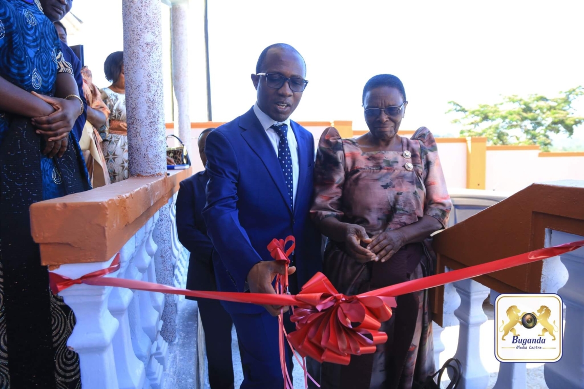 Hon. Joseph Kawuki inaugurates the new office by cutting a ribbon Hon. Joseph Kawuki inaugurates the new office by cutting a ribbon